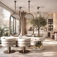 Salon chairs in cream upholstery facing tall arched mirrors, with a small olive tree between them