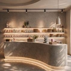 A curved plaster reception counter with warm light along its base and shelves of skincare products behind it